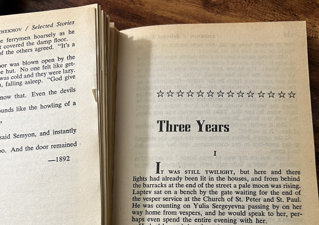 An open copy of Anton Chekhov’s Selected Short Stories, showing the title page for the story "Three Years."