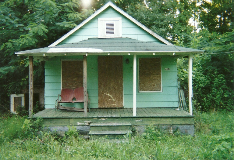 Front view of the historic Hezekiah Carter homeplace, a wooden house with a porch where family history and a significant break-in event occurred.